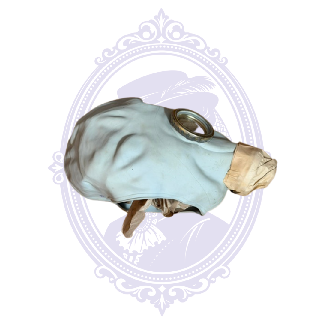 Side view of a 1973 Soviet ShM-62U GP-5 gas mask facepiece from Tambov with original paper retained around the lower assembly.
