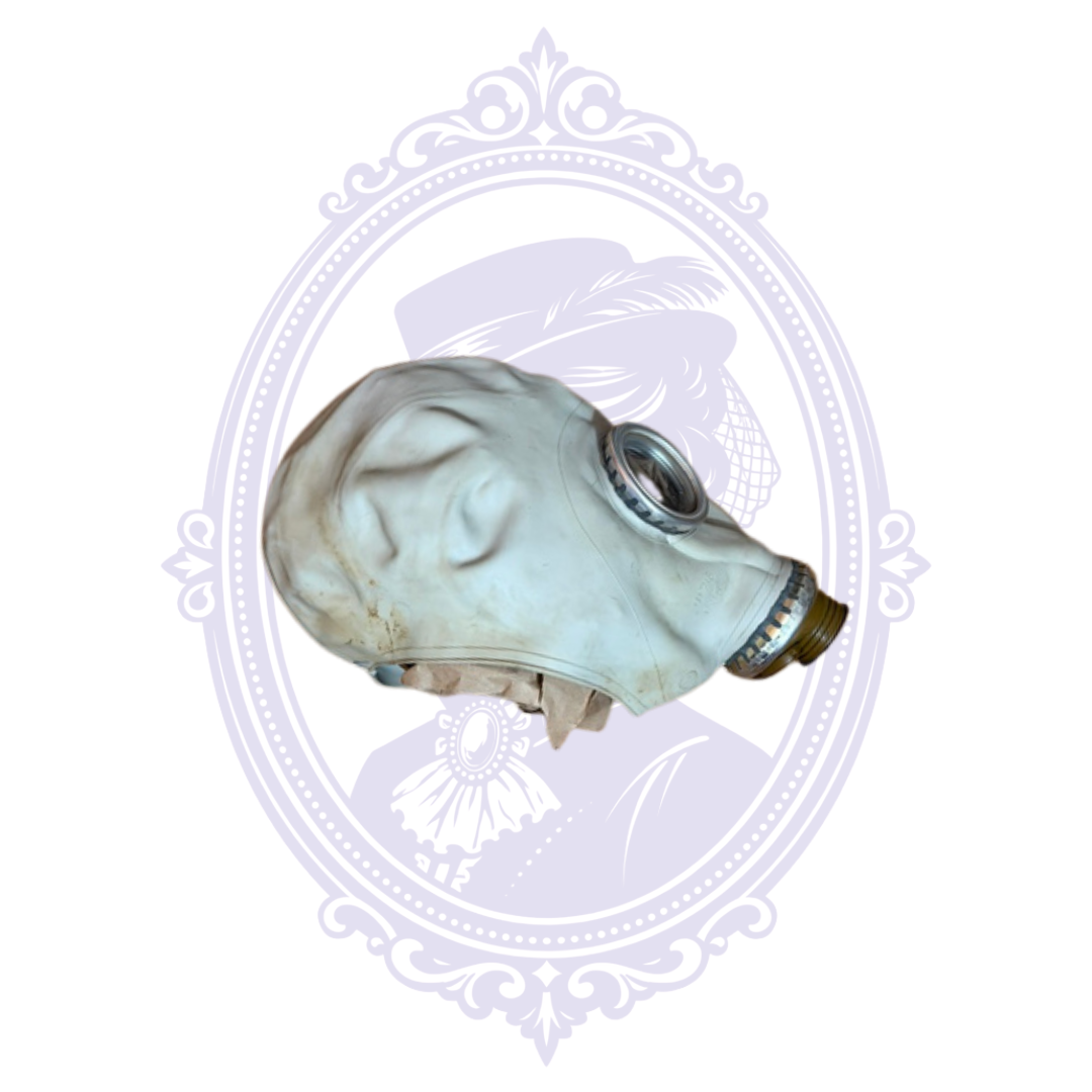 Side view of the 1985 Soviet ShM-62U GP-5 gas mask facepiece with factory code С, showing vintage discoloration and exposed filter connection.