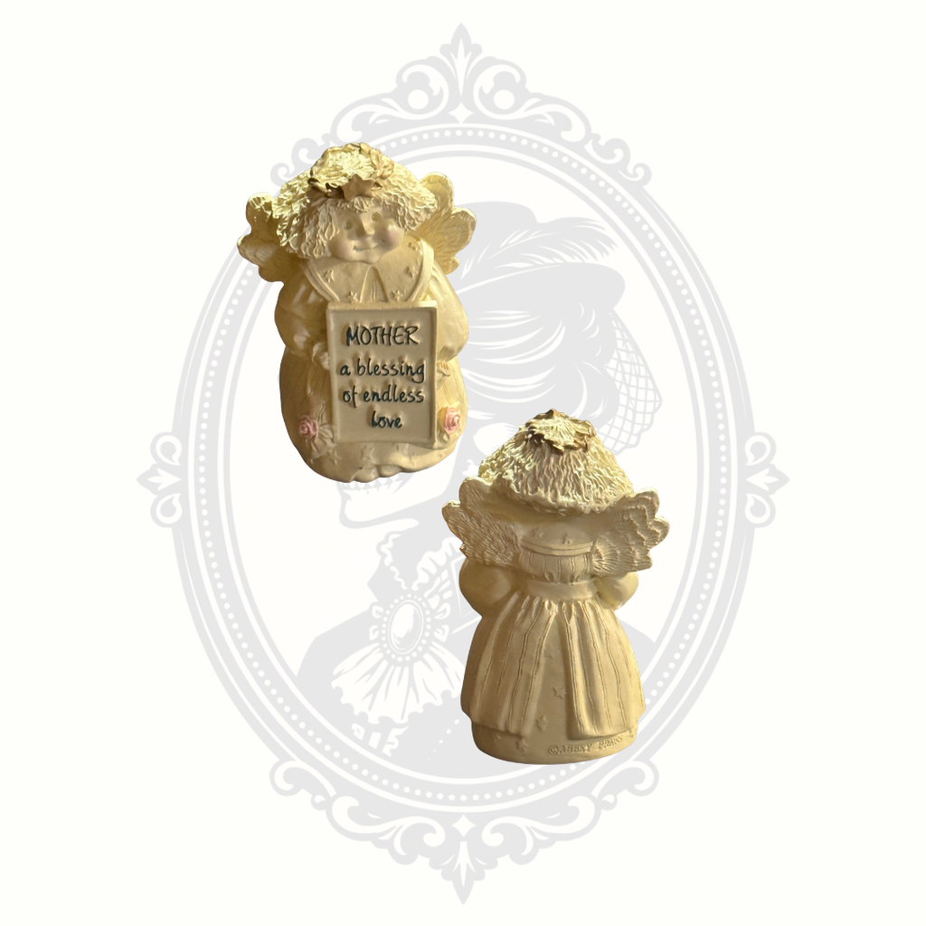 Front and back view of vintage Abbey Press angel figurine holding a “Mother a blessing of endless love” sign.