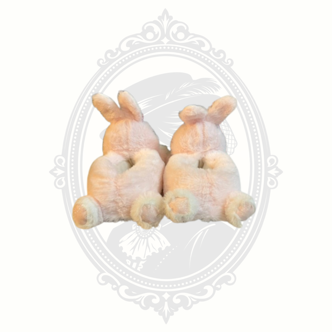 Back view of pink bunny slippers showing plush tails and rounded shape