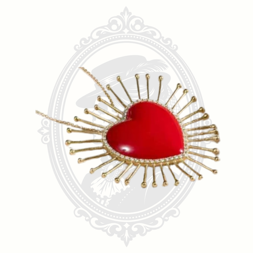 Close-up detail of the ClaudiaG Lumi Necklace showing the red heart centerpiece and decorative gold-tone rays.