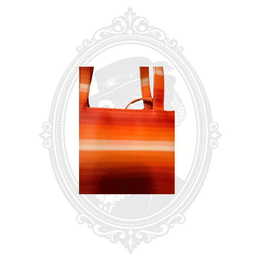 Close-up detail of orange striped fabric and strap stitching on Liz Claiborne tote bag