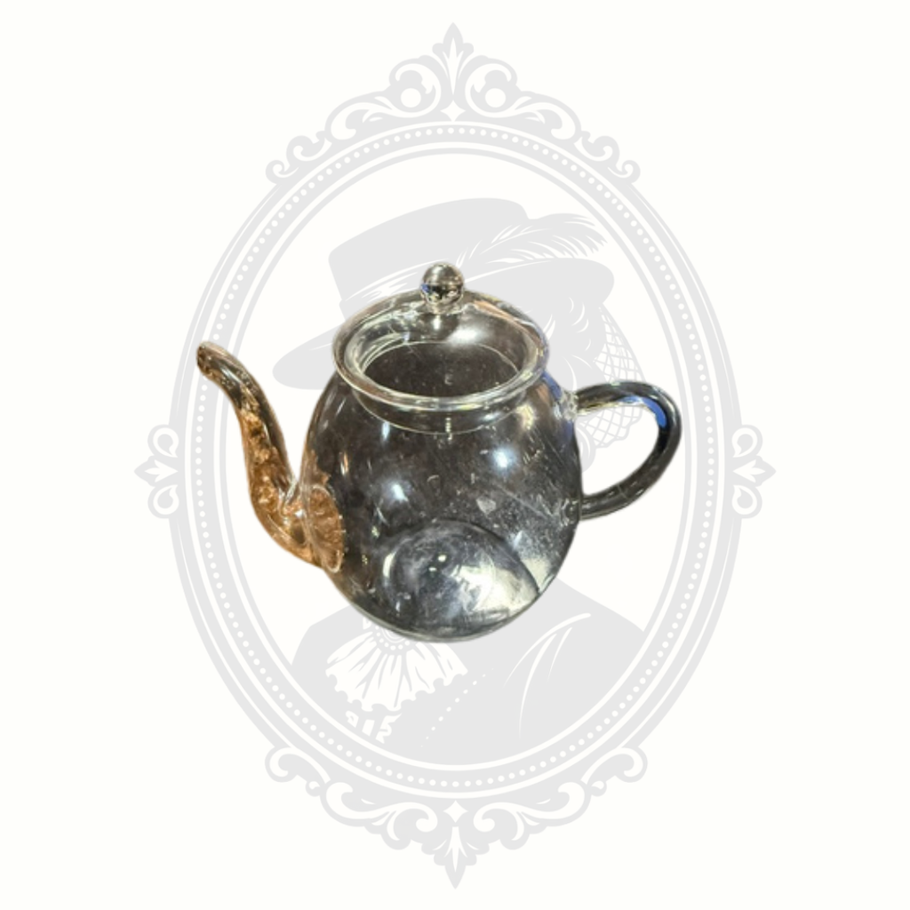 Side profile of minimalist Creano glass teapot showing elegant curved handle and rounded body design.