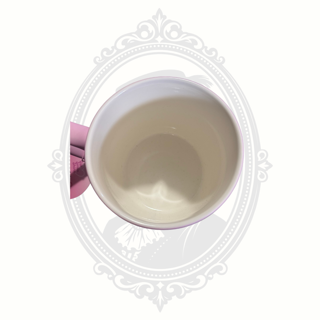 Inside of pink DesirableSip stoneware mug displaying colorful dog artwork and attached original retail tag.