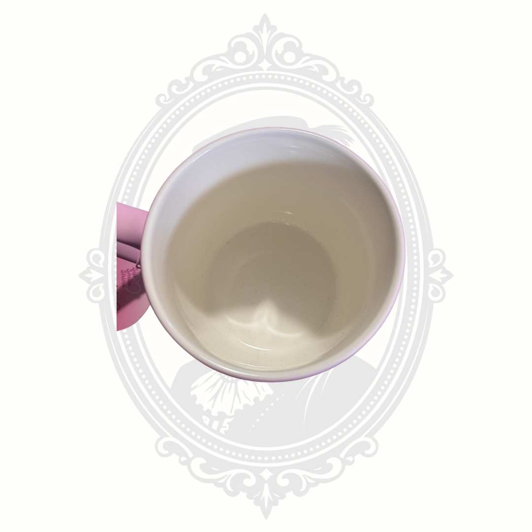Inside of pink DesirableSip stoneware mug displaying colorful dog artwork and attached original retail tag.