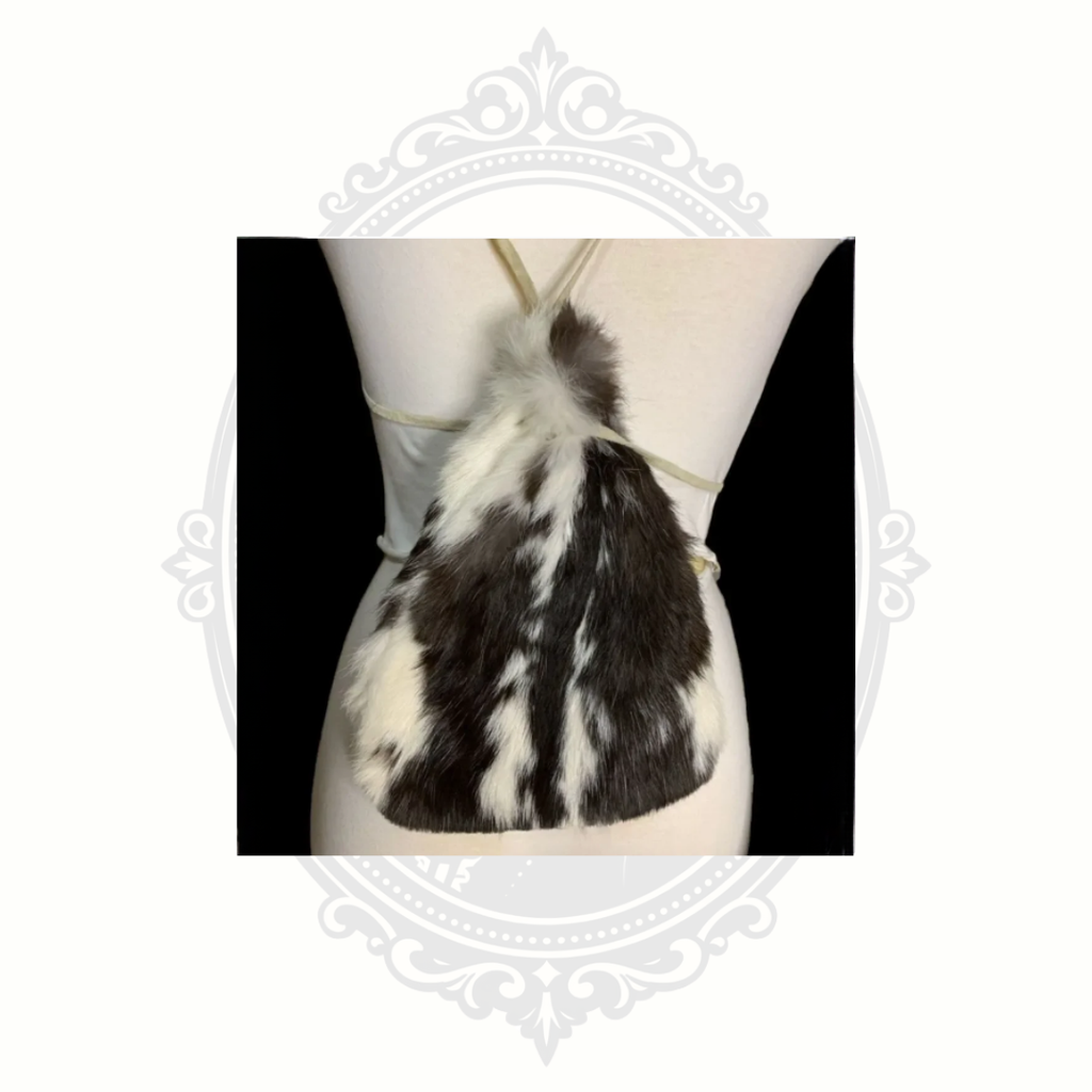 Reverse side of genuine rabbit fur drawstring backpack purse displayed on mannequin