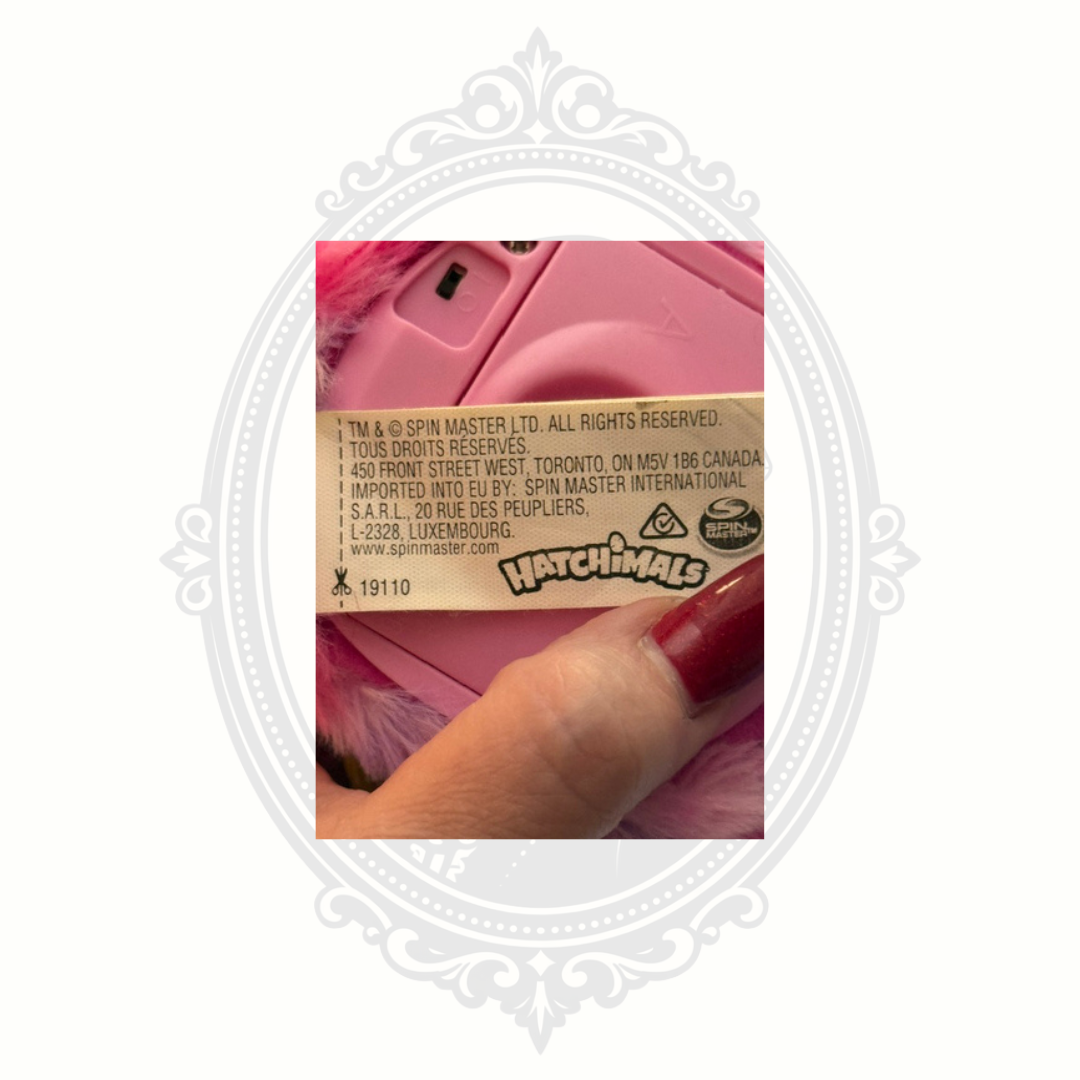Close-up of Hatchimals Pixies Spin Master manufacturer and licensing tag