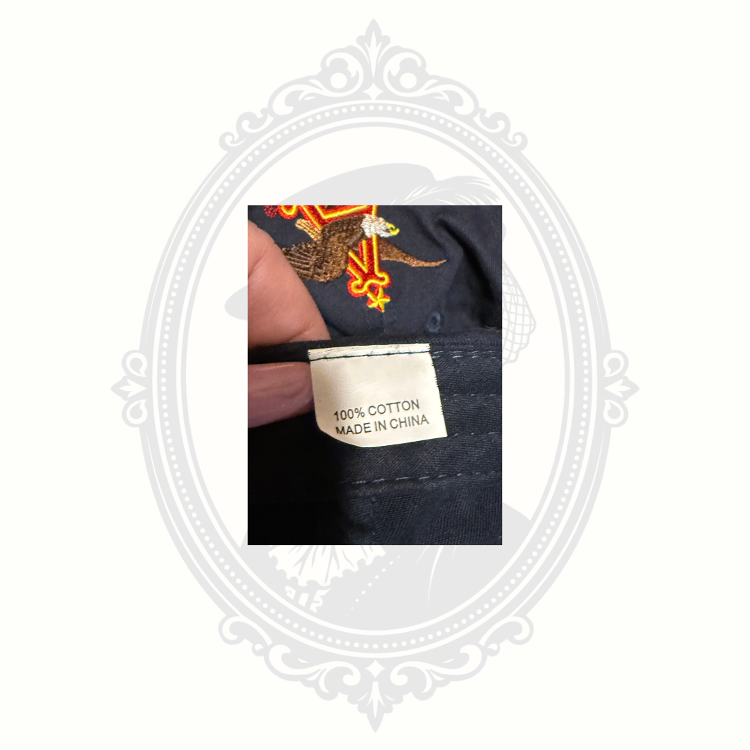 Interior fabric tag inside Budweiser St. Louis Brewery Tour navy cap showing cotton material and country of origin