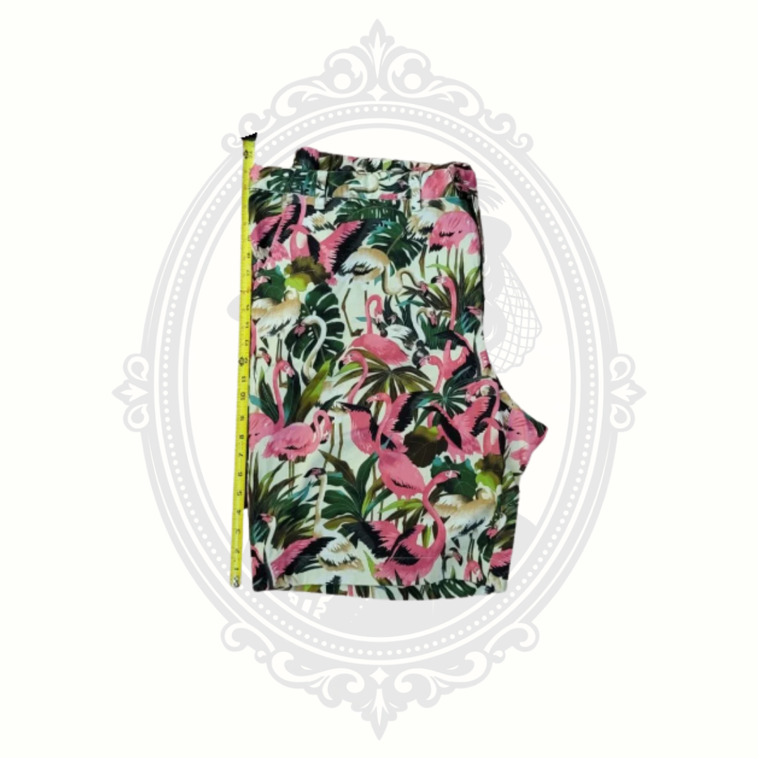 Loudmouth tropical flamingo golf shorts shown with tape measure for length sizing