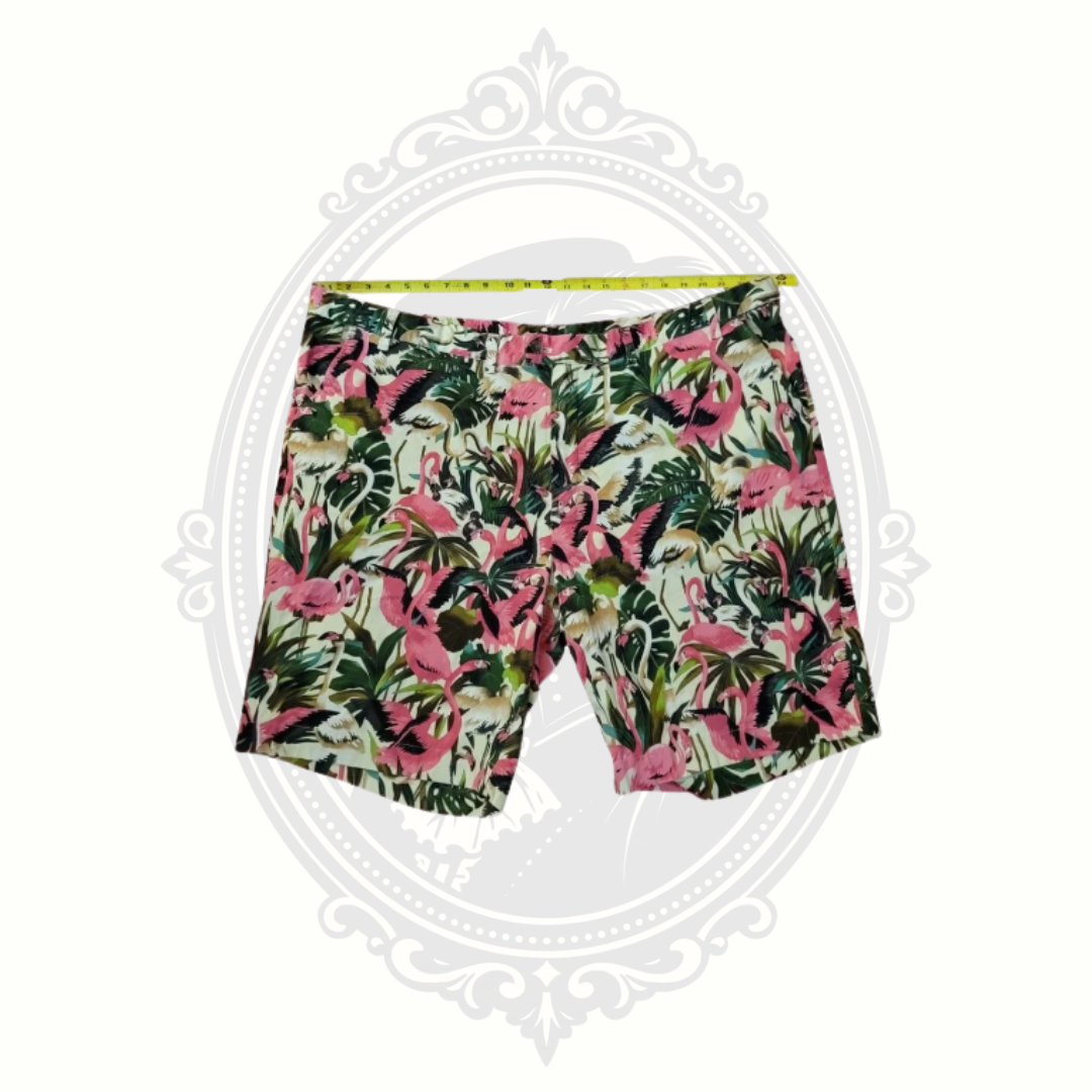 Loudmouth flamingo golf shorts shown with tape measure across waistband