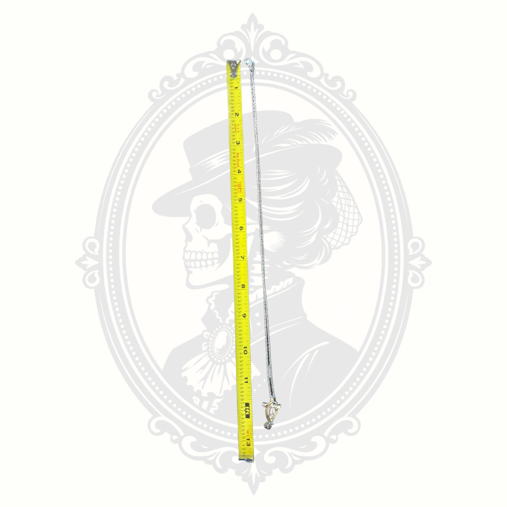 Crystal cross pendant necklace shown beside measuring tape demonstrating approximate chain length.