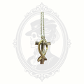 Close-up detail of two-tone cross pendant with crystal accent from the Melanie Jewelry Collection.