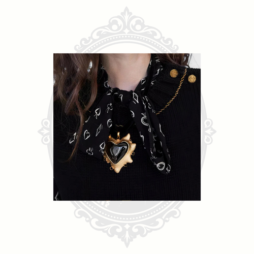 Model wearing ClaudiaG black heart statement necklace