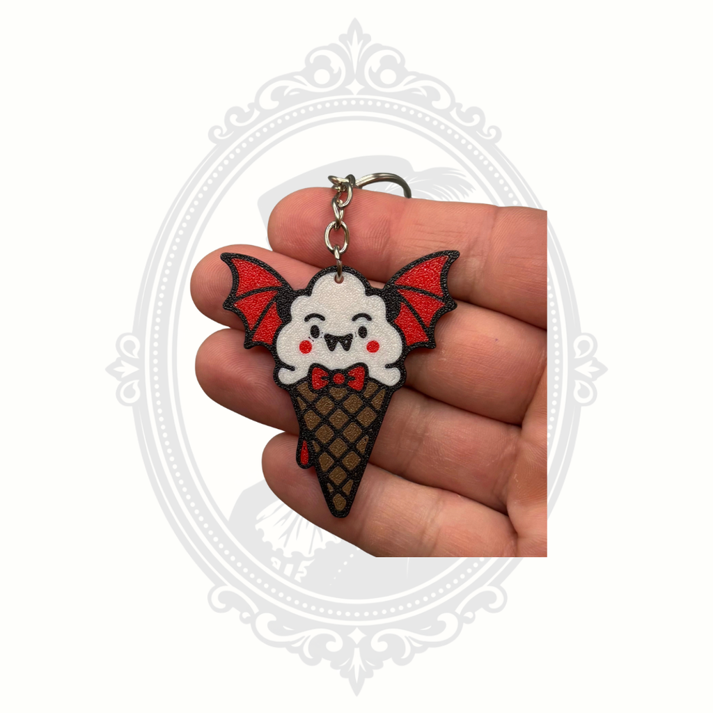 Battie Cream keychain shown in the palm of a hand to demonstrate its collectible size and detailed bat-themed ice cream cone design.
