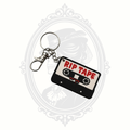 RIP Tape keychain featuring a black and white retro cassette tape with dripping red "RIP TAPE" lettering, metal keyring, and lobster clasp.