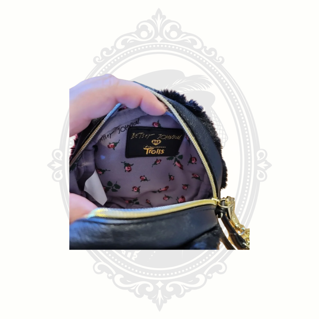Front display of Betsey Johnson troll purse featuring colorful novelty character artwork.