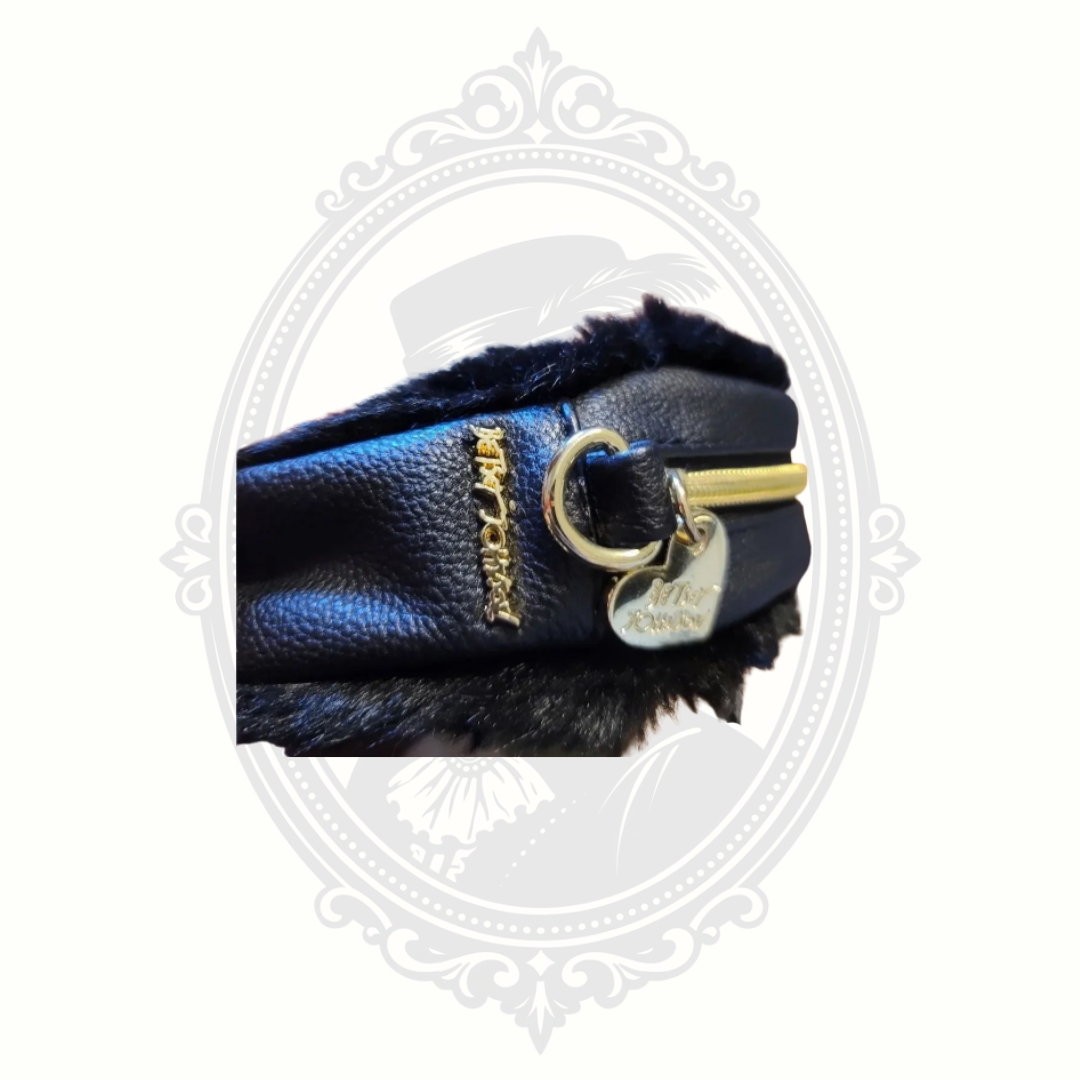 Close-up of Betsey Johnson trolls bag hardware and decorative zipper detailing.