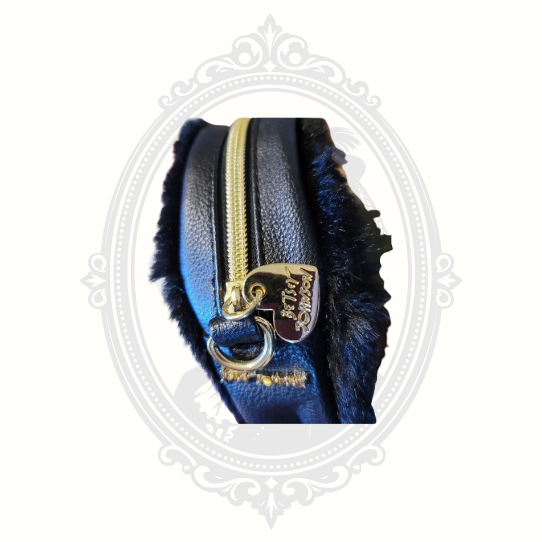 Interior view of Betsey Johnson troll crossbody bag showing storage compartment and lining.