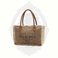 Brown tote bag with leather handles and visible branding on a white background