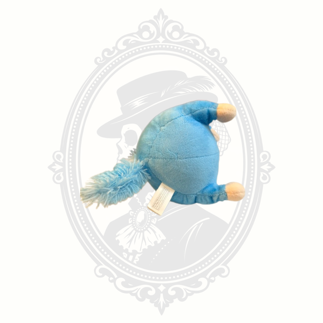 Bottom view of a soft blue unicorn dog plush toy showing underside stitching and fluffy tail detail.
