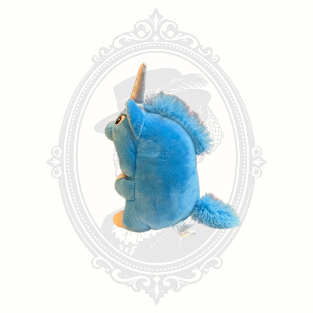 Left side profile of a blue unicorn dog plush toy with fuzzy blue mane, glitter horn, and fluffy tail.