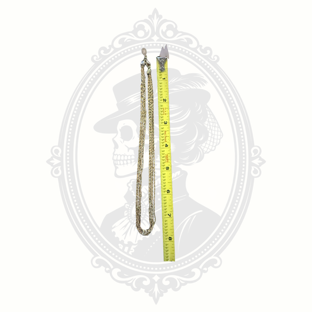 Vintage signed Nolan Miller gold-tone multi-strand necklace displayed beside a measuring tape to show approximate necklace length.