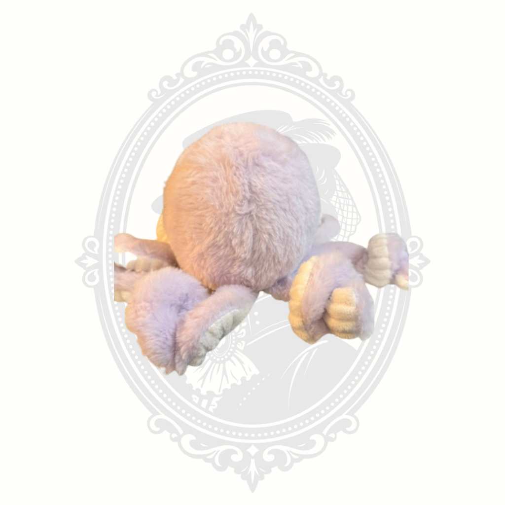 Soft pastel octopus plush toy with embroidered face and textured tentacles.