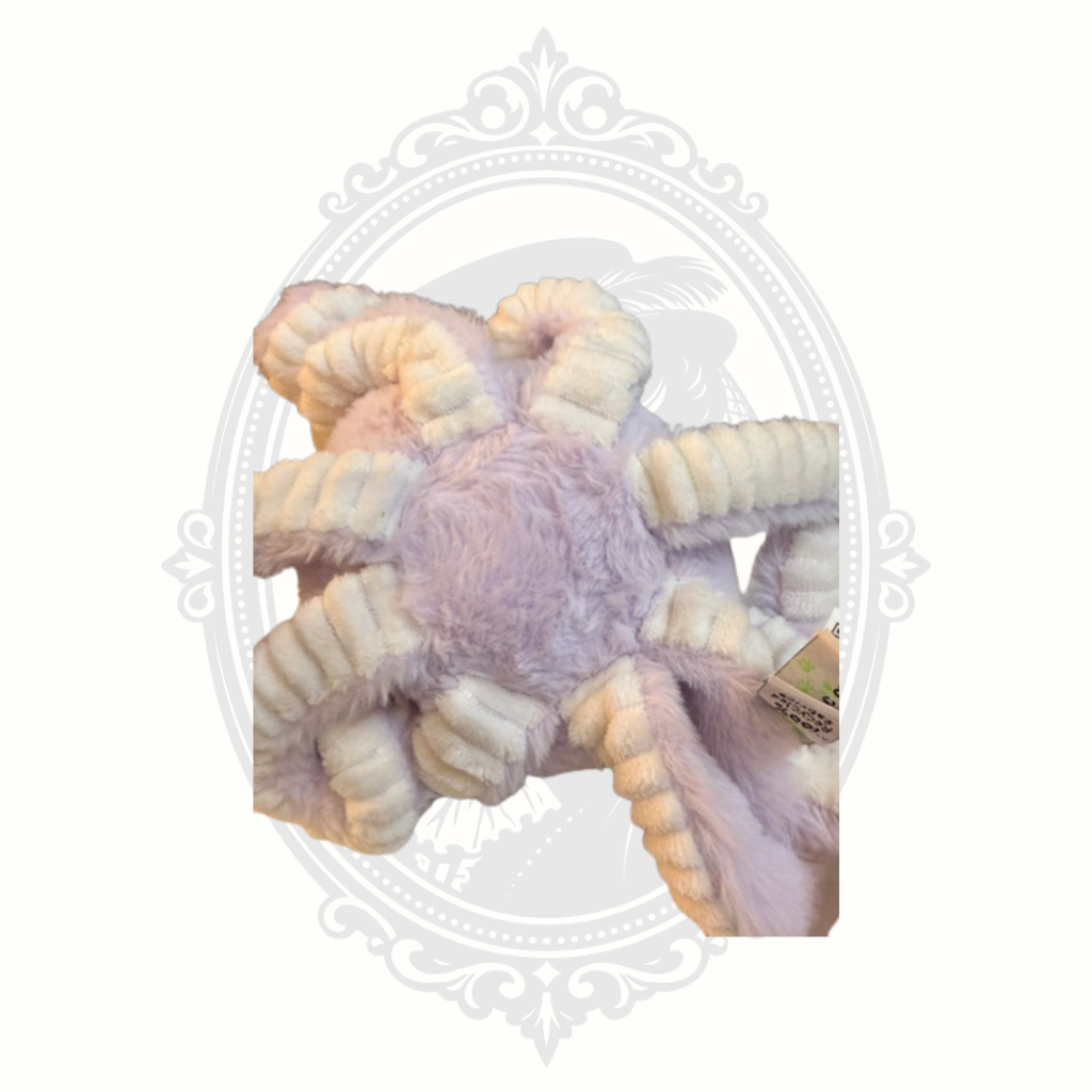 Soft pastel octopus plush toy with embroidered face and textured tentacles.
