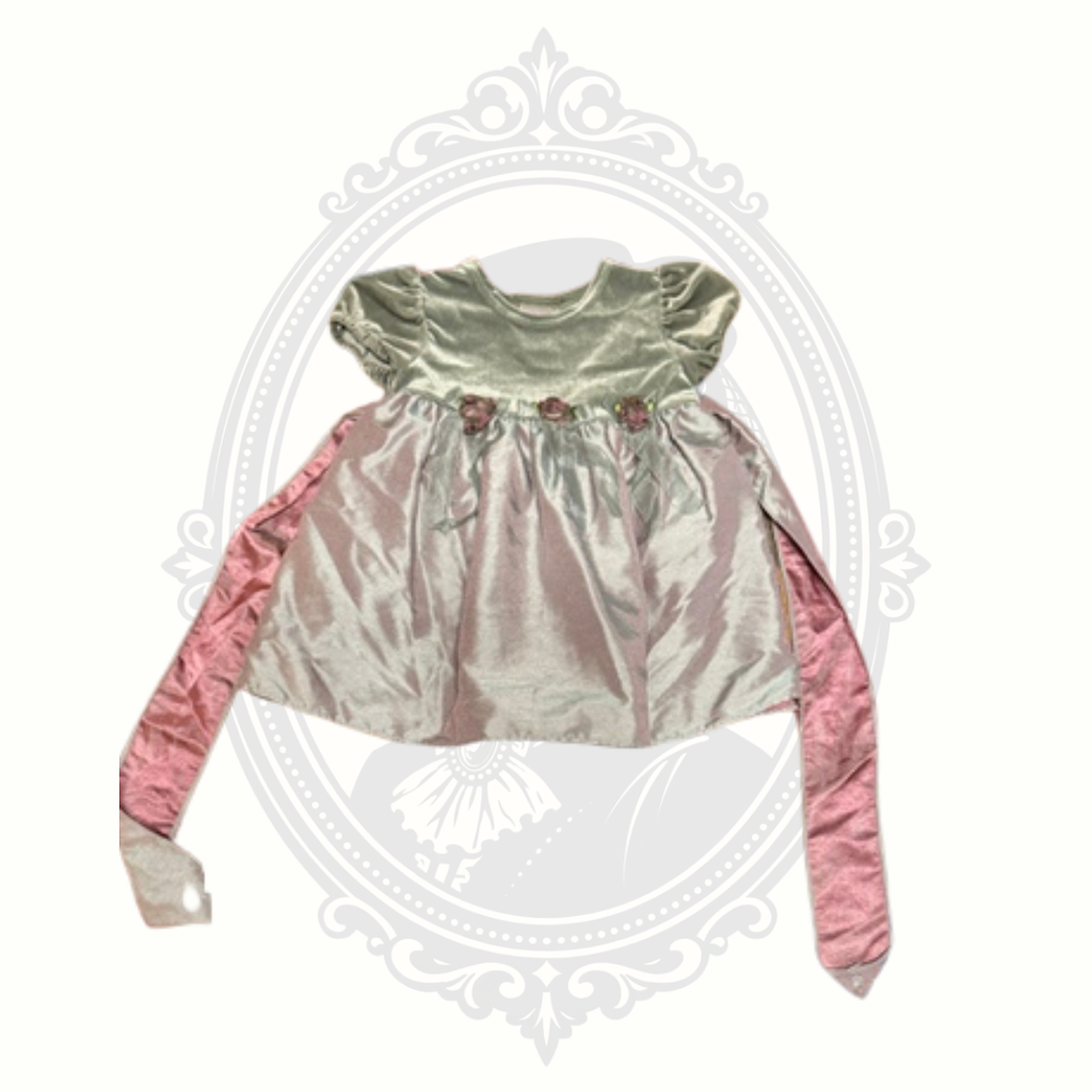 Pink baby girl dress with velvet bodice, satin-look skirt, floral waist accents, and long sash ties displayed against a neutral background.