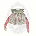Pink baby girl dress with velvet bodice, satin-look skirt, floral waist accents, and long sash ties displayed against a neutral background.