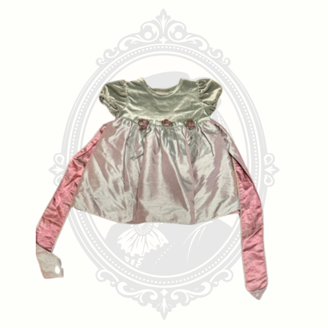 Pink baby girl dress with velvet bodice, satin-look skirt, floral waist accents, and long sash ties displayed against a neutral background.