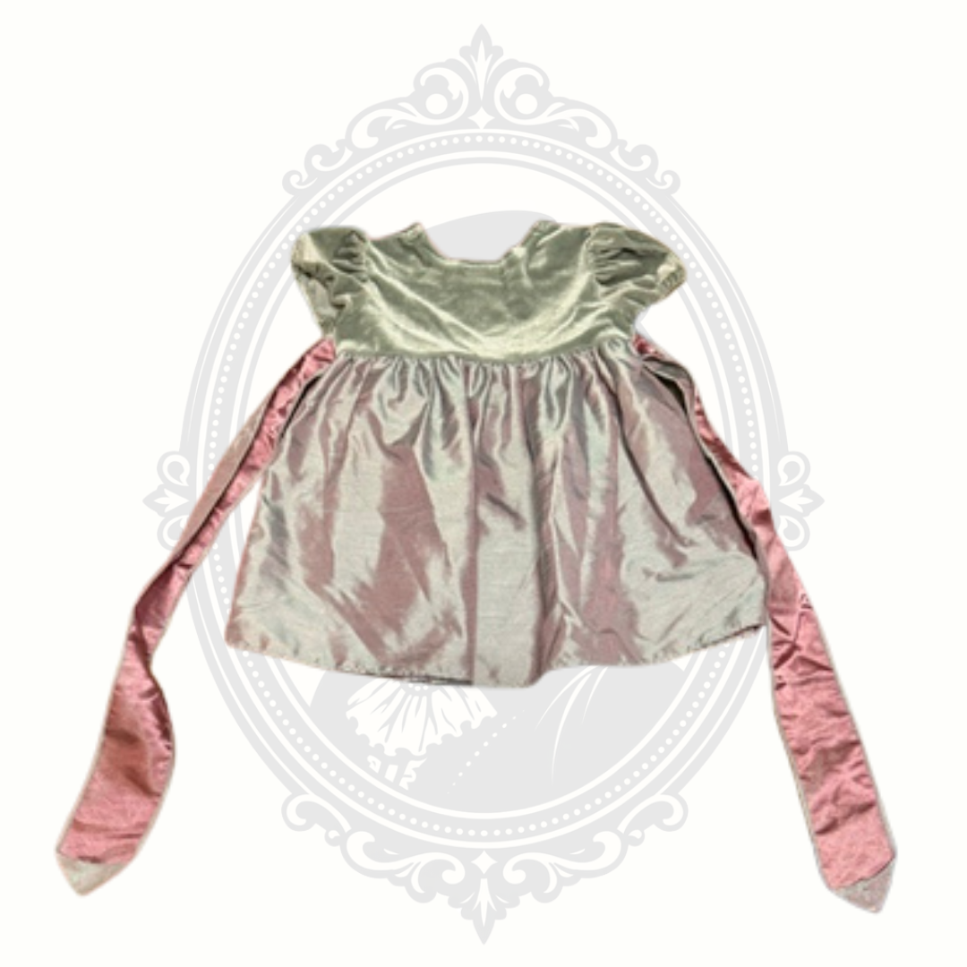 Back view of pink toddler special occasion dress featuring attached satin sash ties and velvet upper bodice.