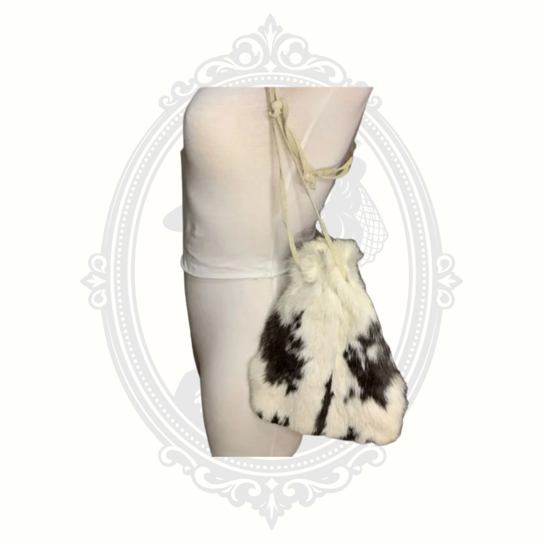 Side profile of vintage rabbit fur drawstring purse with long shoulder straps