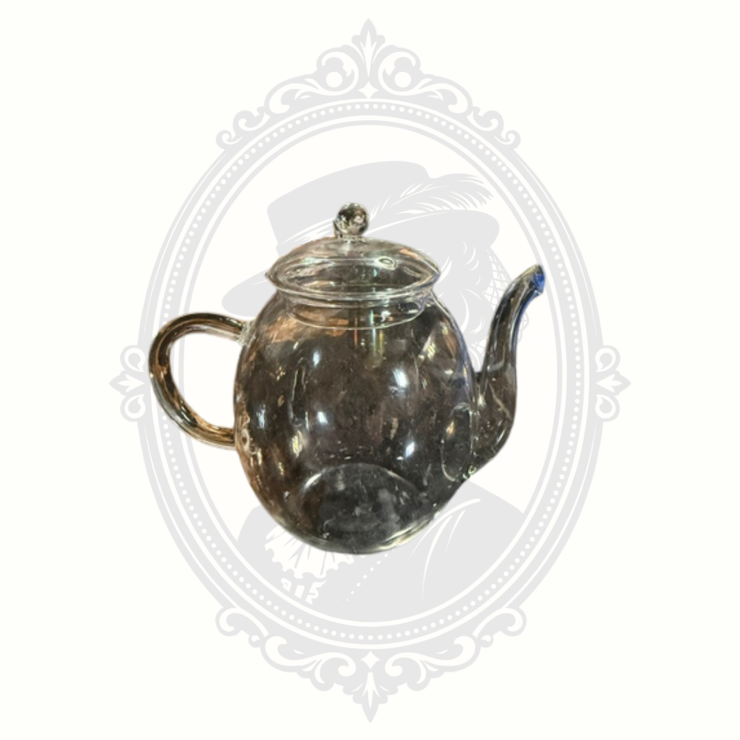 Overhead view of transparent Creano teapot with removable glass lid and visible vent opening.