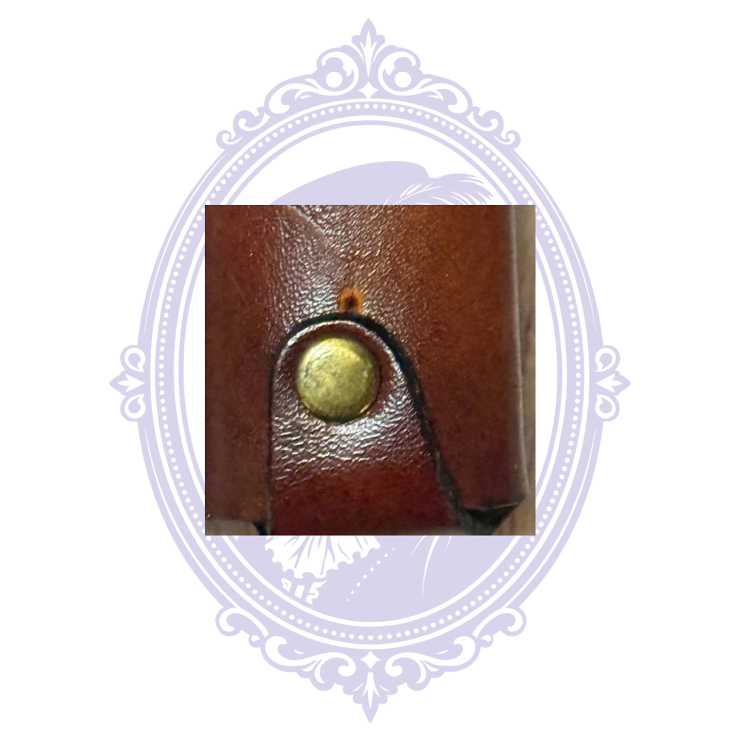 Close-up of brass-tone rivet on vintage leather lighter holder