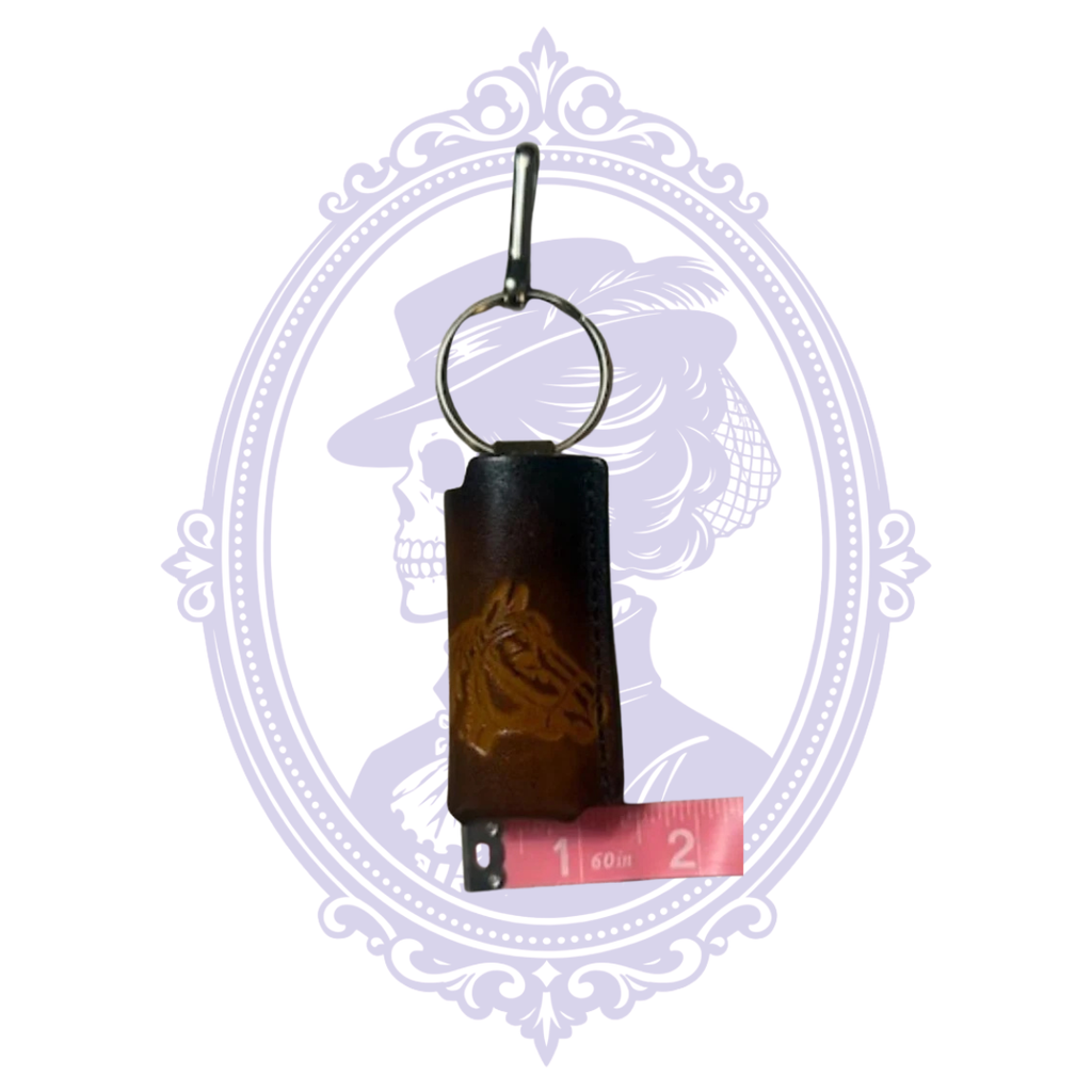 Horse head leather lighter holder beside measuring tape