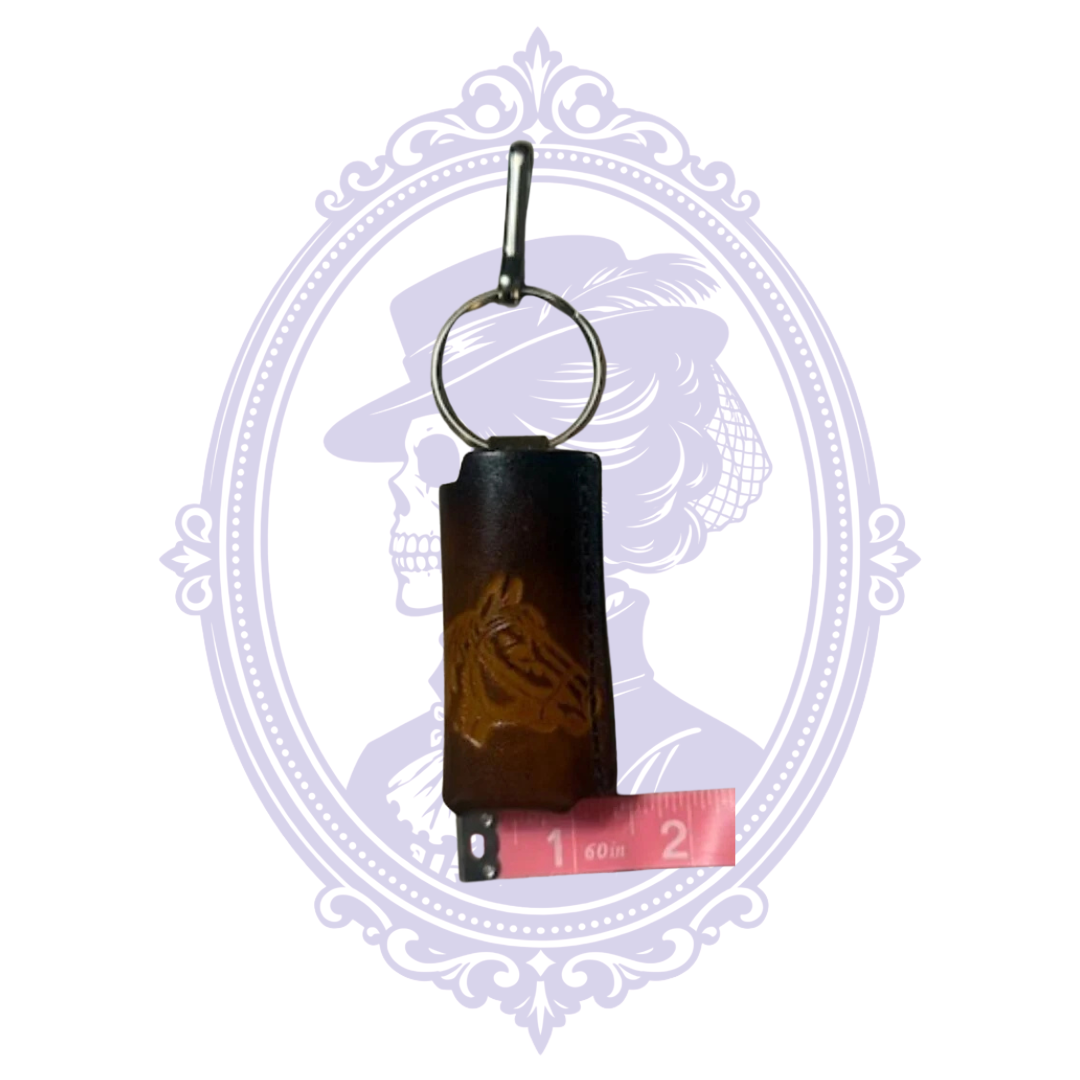 Horse head leather lighter holder beside measuring tape