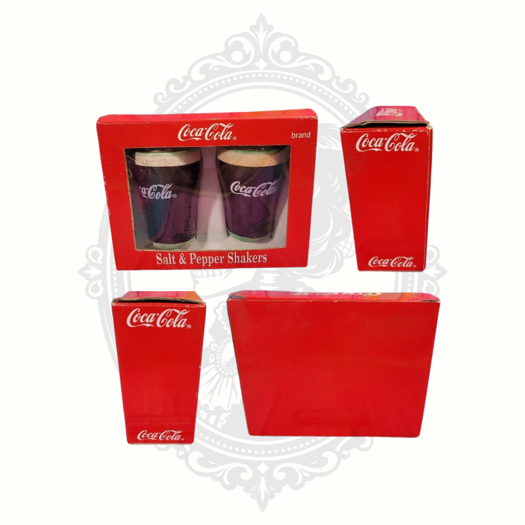Multiple angle views of the original 1999 Coca-Cola salt and pepper shaker packaging showing front, side, and back box condition details.
