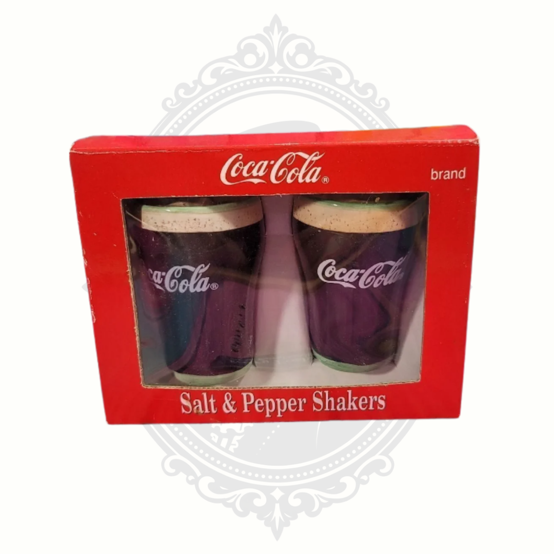 Vintage 1999 Coca-Cola salt and pepper shaker set in original red packaging featuring classic Coke cup-shaped ceramic shakers.