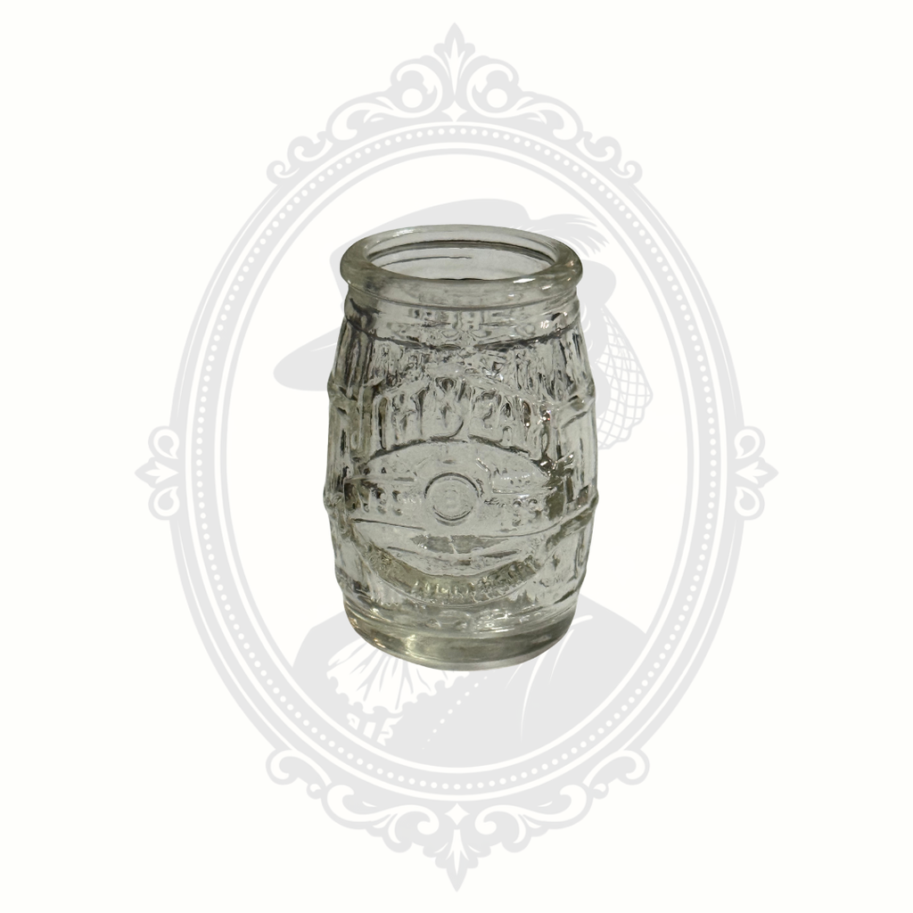 Vintage set of four Jim Beam whiskey barrel shot glasses featuring embossed branding and classic barware styling.