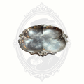 Angled view of ornate vintage silverplated divided serving dish by Wm. Rogers with decorative scroll edge detail.