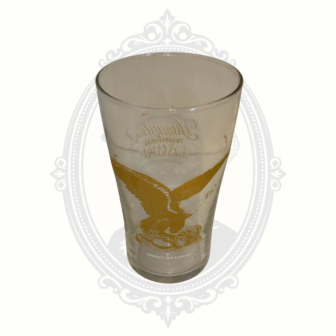 Reverse side of clear Yuengling Traditional Lager pint glass with brewery branding and eagle logo detail.