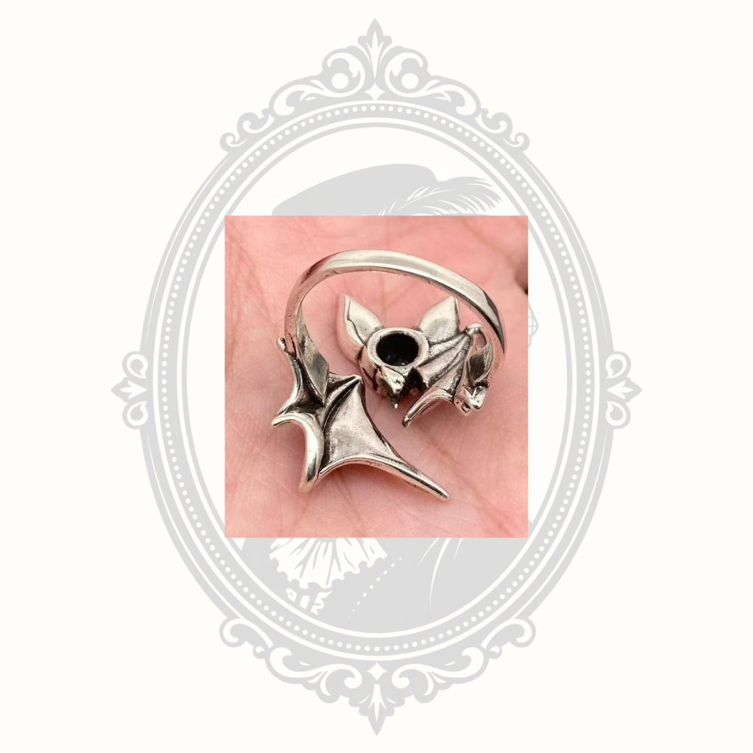Back view of the adjustable silver bat ring highlighting the open band construction.