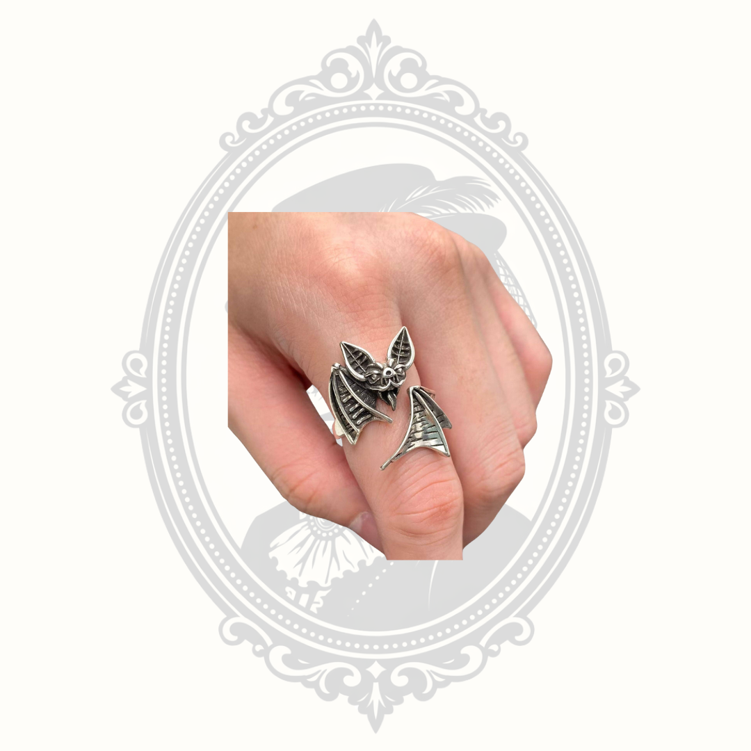 Adjustable silver-tone bat ring displayed on a hand showing the wraparound wing design.