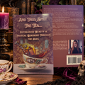 And Thus Spilt the Tea by Dorey Duncan Scott displayed in a gothic setting with teacups, candlelight and a skull.