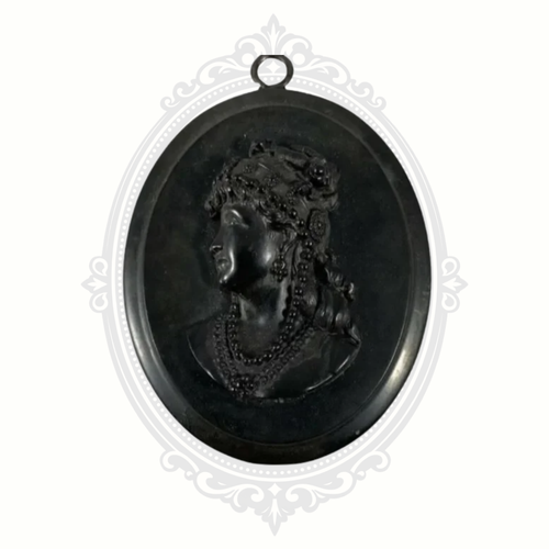 Antique black cameo pendant with raised profile of a woman wearing beaded jewelry, set in an oval frame with hanging loop