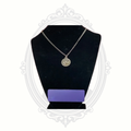 Apryl Dawn unicorn pendant necklace displayed on black jewelry bust