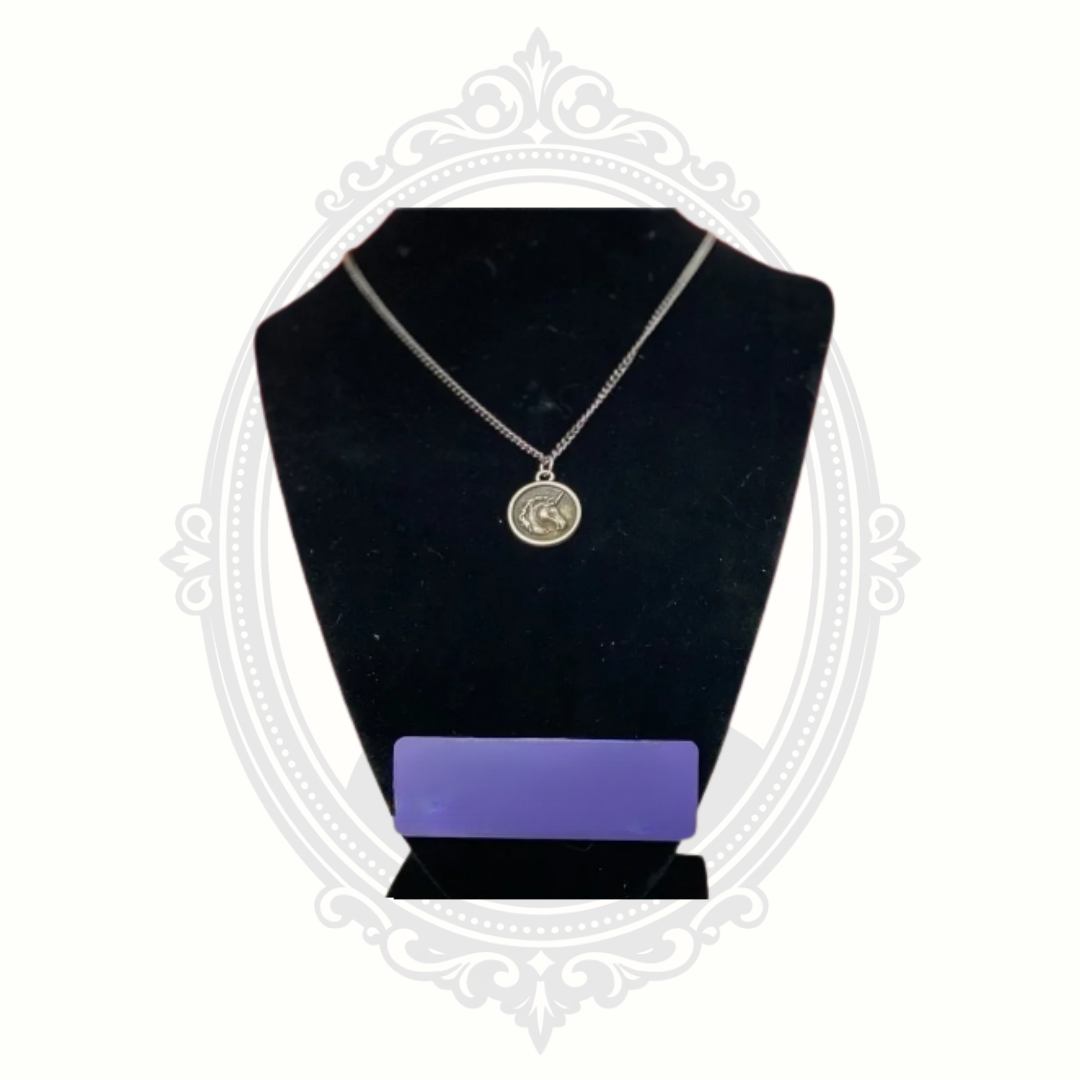 Apryl Dawn unicorn pendant necklace displayed on black jewelry bust
