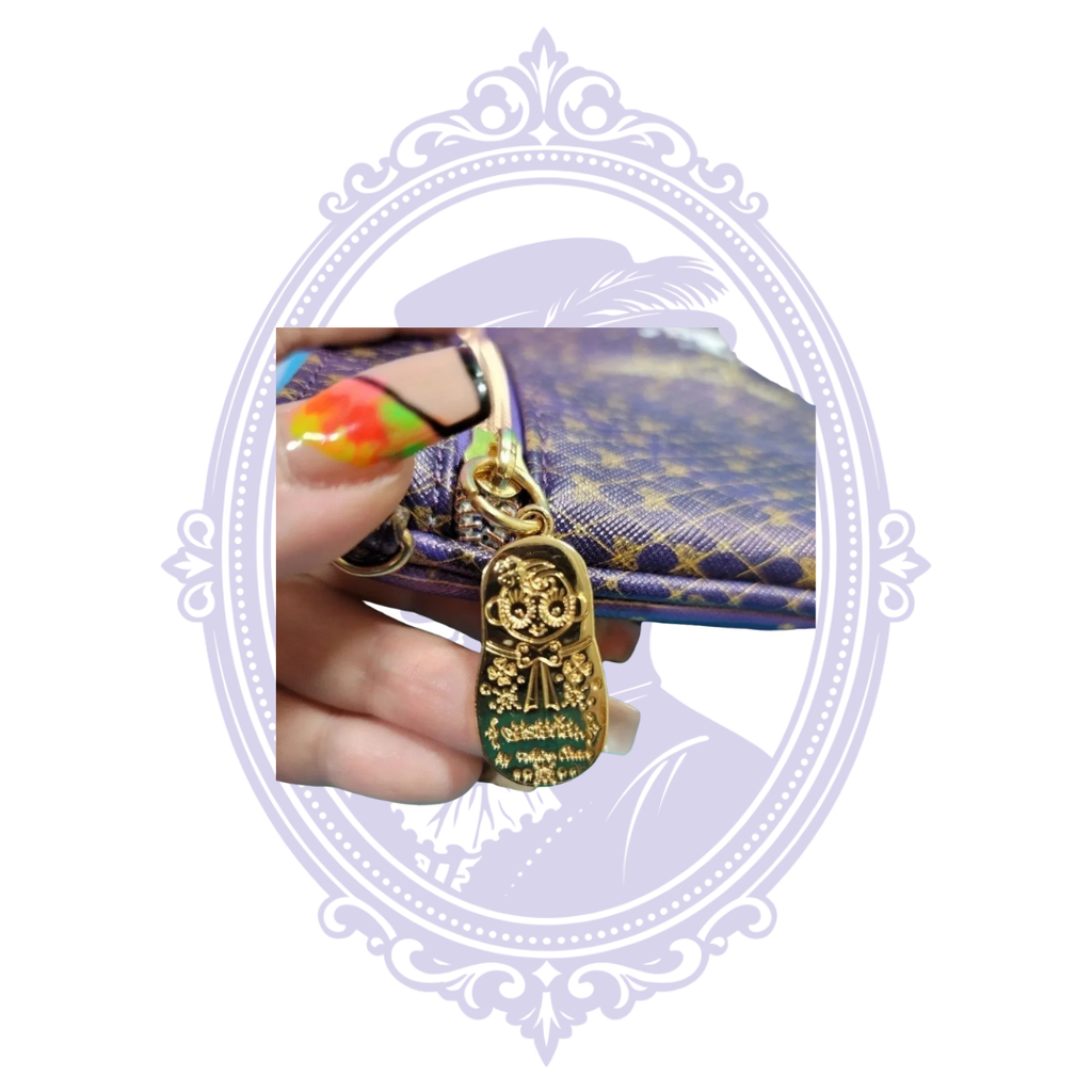 Gold-tone decorative charm on clutch