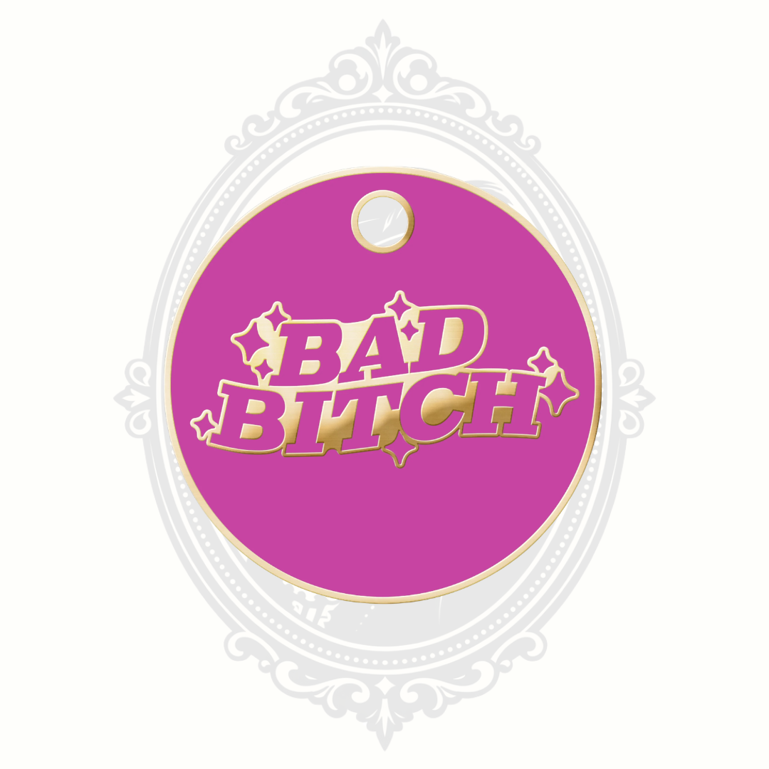 Pink novelty pet tag featuring the phrase “Bad Bitch” with gold-tone lettering.
